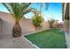 Relax in this low-maintenance backyard featuring vibrant artificial turf, desert plants, and block wall at 7992 Barntucket Ave, Las Vegas, NV 89147