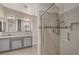 Modern bathroom featuring dual sink vanity, framed mirrors, and a glass enclosed shower at 7992 Barntucket Ave, Las Vegas, NV 89147