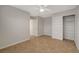 Tile flooring, a ceiling fan, neutral walls, and a closet are features of this bedroom at 7992 Barntucket Ave, Las Vegas, NV 89147