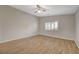 Well-lit bedroom featuring tile flooring, ceiling fan, and a window with plantation shutters at 7992 Barntucket Ave, Las Vegas, NV 89147