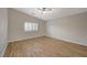 Spacious bedroom with tile flooring, ceiling fan, and a window with plantation shutters at 7992 Barntucket Ave, Las Vegas, NV 89147