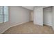 View of an empty bedroom with tile floors, an open closet and a shuttered window at 7992 Barntucket Ave, Las Vegas, NV 89147