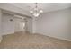 Spacious dining room with chandelier, neutral color palette, and tile flooring at 7992 Barntucket Ave, Las Vegas, NV 89147