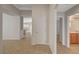 Hallway view showing neutral walls, tile flooring, and an open floor plan at 7992 Barntucket Ave, Las Vegas, NV 89147