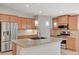 Close up of the island, stainless-steel refrigerator, and appliances at 7992 Barntucket Ave, Las Vegas, NV 89147