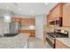 Kitchen featuring granite countertops, stainless steel appliances, and wooden cabinets at 7992 Barntucket Ave, Las Vegas, NV 89147