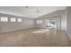 Bright living room with vaulted ceiling, tile flooring, and sliding glass doors leading to the backyard at 7992 Barntucket Ave, Las Vegas, NV 89147