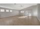 Bright living room with vaulted ceiling, tile flooring, and sliding glass doors leading to the backyard at 7992 Barntucket Ave, Las Vegas, NV 89147