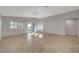 Bright living room with vaulted ceiling, tile flooring, and sliding glass doors leading to the backyard at 7992 Barntucket Ave, Las Vegas, NV 89147