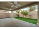 Covered patio has brick pavers, ceiling fans, artificial grass and mature landscaping at 7992 Barntucket Ave, Las Vegas, NV 89147