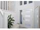 Bright entryway with white door, bench, and staircase to upper level at 8125 Monsoon Bay St, Las Vegas, NV 89113