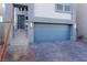 Attached garage with paver driveway and modern light fixtures at 8125 Monsoon Bay St, Las Vegas, NV 89113