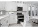 White kitchen with stainless steel appliances and view at 8125 Monsoon Bay St, Las Vegas, NV 89113