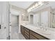 Bathroom featuring double sinks with wood-look floors at 8201 Lake Isle Ct, Las Vegas, NV 89145