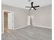 Bright bedroom with wood floors and a ceiling fan at 8201 Lake Isle Ct, Las Vegas, NV 89145