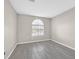 Bedroom with wood-look tile flooring and a large window at 8201 Lake Isle Ct, Las Vegas, NV 89145