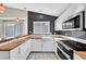 Updated kitchen featuring sleek appliances, butcher block countertops, and ample natural light from the window at 8201 Lake Isle Ct, Las Vegas, NV 89145