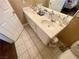 Bathroom with double sinks and a vanity with tile flooring in a neutral coloring at 8203 Heather Rock Ct, Las Vegas, NV 89117