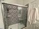 Bathroom showcasing a glass-enclosed shower with decorative patterned tile at 8203 Heather Rock Ct, Las Vegas, NV 89117