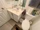 Bathroom featuring a white vanity, toilet, and tile flooring at 8203 Heather Rock Ct, Las Vegas, NV 89117