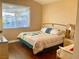 Bedroom with a large window and wood-style flooring at 8203 Heather Rock Ct, Las Vegas, NV 89117