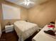 Cozy bedroom featuring a ceiling fan, window with blinds, and neutral color scheme at 8203 Heather Rock Ct, Las Vegas, NV 89117