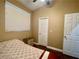 Neutral colored bedroom with a ceiling fan, a window for natural light, and an adjacent closet at 8203 Heather Rock Ct, Las Vegas, NV 89117