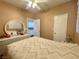 Bright bedroom with neutral walls, ceiling fan, and view to the kitchen at 8203 Heather Rock Ct, Las Vegas, NV 89117