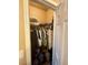 Walk-in closet with rods and shelving, filled with hanging clothes and storage items at 8203 Heather Rock Ct, Las Vegas, NV 89117