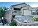 Inviting exterior of this home with garage, desert landscaping, and unique statuary at 8203 Heather Rock Ct, Las Vegas, NV 89117