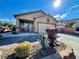 Single-story home with desert landscaping and a paved driveway, enhancing curb appeal at 8203 Heather Rock Ct, Las Vegas, NV 89117