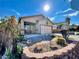 Charming single-story home with a desert-landscaped front yard and a two-car garage at 8203 Heather Rock Ct, Las Vegas, NV 89117