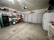 Spacious garage with ample storage space, multiple garage doors, and clean flooring at 8203 Heather Rock Ct, Las Vegas, NV 89117