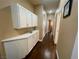 Hallway with wood floors and plenty of storage cabinets at 8203 Heather Rock Ct, Las Vegas, NV 89117