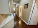 Hallway with hardwood floors leading to other rooms in the house and bathroom at 8203 Heather Rock Ct, Las Vegas, NV 89117