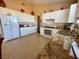 Bright kitchen featuring white cabinets, tile floors, granite counters, and modern appliances at 8203 Heather Rock Ct, Las Vegas, NV 89117