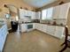 Bright kitchen featuring white cabinetry, tile flooring, and a window for natural light at 8203 Heather Rock Ct, Las Vegas, NV 89117