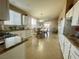 Open kitchen with white cabinetry, granite countertops, and seamless flow to dining area at 8203 Heather Rock Ct, Las Vegas, NV 89117