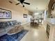 Open-concept living area with a ceiling fan and fireplace next to dining and kitchen at 8203 Heather Rock Ct, Las Vegas, NV 89117