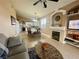 Living area with fireplace that opens to a dining area and kitchen at 8203 Heather Rock Ct, Las Vegas, NV 89117