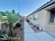 A practical side yard with pathway, low-maintenance landscaping, and wall for privacy at 8203 Heather Rock Ct, Las Vegas, NV 89117