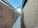 Long narrow side yard between houses showing walkway and archway at 8203 Heather Rock Ct, Las Vegas, NV 89117