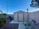 Durable backyard storage shed with a neutral color scheme, perfect for storing tools and equipment at 8203 Heather Rock Ct, Las Vegas, NV 89117