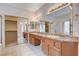 Bathroom with double sinks, granite countertops, a glass-enclosed shower, and ample storage at 85 Alerion St, Las Vegas, NV 89138