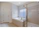 Bright bathroom featuring a soaking tub, glass-enclosed shower, and tile accents at 85 Alerion St, Las Vegas, NV 89138