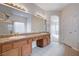 Bathroom featuring dual sinks, a large mirror, and a separate tub and shower area at 85 Alerion St, Las Vegas, NV 89138