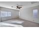 Bedroom featuring neutral carpet, ceiling fan, and a bright window at 85 Alerion St, Las Vegas, NV 89138