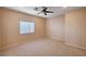 Bright bedroom with a ceiling fan, carpeted floor, and large window at 85 Alerion St, Las Vegas, NV 89138