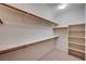 Walk-in closet features wood racks, shelves and ample space for storage at 85 Alerion St, Las Vegas, NV 89138