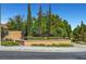 Landscaped community entrance with monument sign, mature trees, and well-maintained grounds at 85 Alerion St, Las Vegas, NV 89138